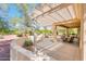 Charming covered patio provides a relaxing outdoor living and entertaining space at 13444 W Cabrillo Dr, Sun City West, AZ 85375
