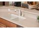 Close-up of the kitchen sink featuring a white faucet and light countertop at 13444 W Cabrillo Dr, Sun City West, AZ 85375