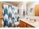Bathroom featuring a vanity with a mirror, wood cabinet, and a shower with a stylish patterned curtain at 1640 E Augusta Ave, Chandler, AZ 85249
