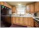 Functional kitchen features wood cabinetry, ample counter space, and modern appliances for cooking convenience at 1640 E Augusta Ave, Chandler, AZ 85249