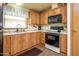 Efficient kitchen features ample cabinetry, dual basin sink, window for natural light, and range at 1640 E Augusta Ave, Chandler, AZ 85249