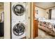 Laundry area featuring a stacked washer and dryer unit, conveniently located near the bedroom at 1640 E Augusta Ave, Chandler, AZ 85249