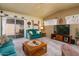 Comfortable living room with ceiling fan, sliding glass door access to patio, and entertainment center at 1640 E Augusta Ave, Chandler, AZ 85249
