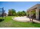 Spacious backyard featuring a lush lawn, tiled patio, and beautiful landscaping at 1804 W Magdalena Ln, Phoenix, AZ 85041