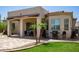 Beautiful backyard with manicured landscaping, tiled patio, and a cozy covered area at 1804 W Magdalena Ln, Phoenix, AZ 85041