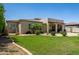 Expansive backyard featuring a well-maintained lawn and a cozy covered patio area at 1804 W Magdalena Ln, Phoenix, AZ 85041