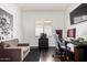 Relaxing bedroom featuring hardwood floors, a gray couch and workspace at 1804 W Magdalena Ln, Phoenix, AZ 85041