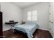 Bedroom with hardwood floors, plantation shutters and neutral walls at 1804 W Magdalena Ln, Phoenix, AZ 85041