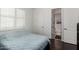 Bedroom featuring dark hardwood floors and bright natural light at 1804 W Magdalena Ln, Phoenix, AZ 85041