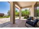 Inviting covered patio with beautiful stone columns and comfortable seating area at 1804 W Magdalena Ln, Phoenix, AZ 85041