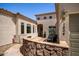 Inviting home featuring a stone wall and patio area with seating near the front entrance at 1804 W Magdalena Ln, Phoenix, AZ 85041
