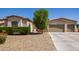 Charming home featuring a desert landscape, a three-car garage and a lush tree providing shade at 1804 W Magdalena Ln, Phoenix, AZ 85041