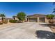 Charming home featuring a desert landscape, a three-car garage and a lush tree providing shade at 1804 W Magdalena Ln, Phoenix, AZ 85041