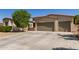 Charming home featuring a desert landscape, a three-car garage and a lush tree providing shade at 1804 W Magdalena Ln, Phoenix, AZ 85041