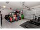 View of an organized garage space with speckled flooring and ample storage at 1804 W Magdalena Ln, Phoenix, AZ 85041
