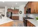 Spacious kitchen with wood cabinets, quartz counters, stainless steel appliances, and tile backsplash at 1804 W Magdalena Ln, Phoenix, AZ 85041