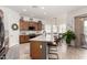Eat-in kitchen features wood cabinets, an island with seating, and an adjacent dining area at 1804 W Magdalena Ln, Phoenix, AZ 85041