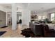 Bright open-concept living room with neutral tile floors, dark wood console table and leather sofa at 1804 W Magdalena Ln, Phoenix, AZ 85041