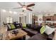 Living room features dark brown leather sofa, wood coffee table and view of eat-in kitchen at 1804 W Magdalena Ln, Phoenix, AZ 85041