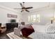 Main bedroom features a bed, a sofa, dark wood floors, and access to ensuite bathroom at 1804 W Magdalena Ln, Phoenix, AZ 85041