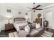 Spacious main bedroom features a queen bed, a comfortable sofa, and wood flooring at 1804 W Magdalena Ln, Phoenix, AZ 85041