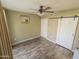 Comfortable bedroom featuring a fan, wood floors, and a double door slider closet at 1825 W Ray Rd # 1134, Chandler, AZ 85224