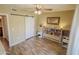 Bright bedroom featuring modern ceiling fan, barn door, and a built in bookcase headboard at 1825 W Ray Rd # 1134, Chandler, AZ 85224