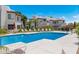 Sparkling community pool surrounded by lounge chairs and well maintained landscaping at 1825 W Ray Rd # 1134, Chandler, AZ 85224