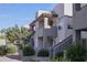 Condominium exterior featuring private balconies, desert landscaping, and neutral stucco facade at 1825 W Ray Rd # 1134, Chandler, AZ 85224