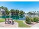 Picturesque lake view with benches, blooming bushes, and swaying trees, offering a serene retreat at 1825 W Ray Rd # 1134, Chandler, AZ 85224