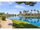 Beautiful lake view with lush landscaping and nearby residential buildings on a clear, sunny day at 1825 W Ray Rd # 1134, Chandler, AZ 85224