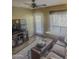 Comfortable living room features a ceiling fan, a plush sofa, and natural light, highlighting a relaxing space at 1825 W Ray Rd # 1134, Chandler, AZ 85224