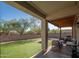 View of the covered patio and backyard featuring seating and an artificial lawn at 18401 W Westfall Way, Surprise, AZ 85374