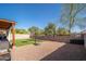 Spacious backyard includes turf, gravel, and a basketball hoop, great for entertaining at 18401 W Westfall Way, Surprise, AZ 85374