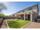 The backyard with green turf, a patio, and basketball hoop enhances outdoor living at 18401 W Westfall Way, Surprise, AZ 85374