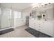 Bright bathroom with a double vanity, large mirror and separate bathtub at 18401 W Westfall Way, Surprise, AZ 85374