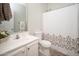 Cozy bathroom with sink, toilet and shower with a shower curtain at 18401 W Westfall Way, Surprise, AZ 85374