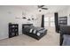 This bedroom has a ceiling fan, hats on a shelf, and sports decor at 18401 W Westfall Way, Surprise, AZ 85374