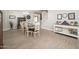 Spacious dining area with stylish lighting, a rustic cabinet, and staircase access, perfect for Gathering gatherings at 18401 W Westfall Way, Surprise, AZ 85374