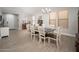 Elegant dining room featuring a modern chandelier, large windows, and a long table with seating for eight at 18401 W Westfall Way, Surprise, AZ 85374