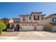 Charming two-story home with a three-car garage and well-manicured front yard in a quiet neighborhood at 18401 W Westfall Way, Surprise, AZ 85374