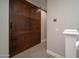 Hallway with modern barn door and hardwood floors that provide space and modern aesthetic at 18401 W Westfall Way, Surprise, AZ 85374
