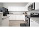 Kitchen featuring white cabinets, stainless appliances, granite countertops, and breakfast bar at 18401 W Westfall Way, Surprise, AZ 85374