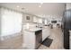 Bright kitchen featuring granite countertops, stainless steel appliances, and open layout to living area at 18401 W Westfall Way, Surprise, AZ 85374