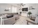 Cozy living room featuring shiplap accent wall, comfortable seating, and ample natural light for relaxation at 18401 W Westfall Way, Surprise, AZ 85374