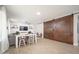 Open-concept living room with table and chairs, connecting to the kitchen, offering a versatile living space at 18401 W Westfall Way, Surprise, AZ 85374