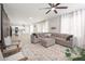 Spacious living room with a large sectional sofa, ceiling fan, and adjacent kitchen at 18401 W Westfall Way, Surprise, AZ 85374