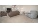 Comfortable living room with plush furniture, ceiling fan and natural light at 18401 W Westfall Way, Surprise, AZ 85374