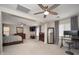 Spacious main bedroom featuring neutral walls, ceiling fan, and walk-in closet at 18401 W Westfall Way, Surprise, AZ 85374