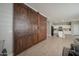 A view of the rustic sliding pantry doors leading to the kitchen, adding a touch of charm to the home at 18401 W Westfall Way, Surprise, AZ 85374